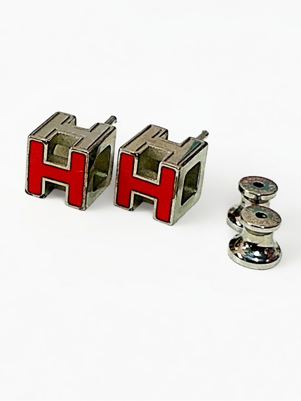 Hermès Cage d'H earrings featuring a red enamel H-shaped cube